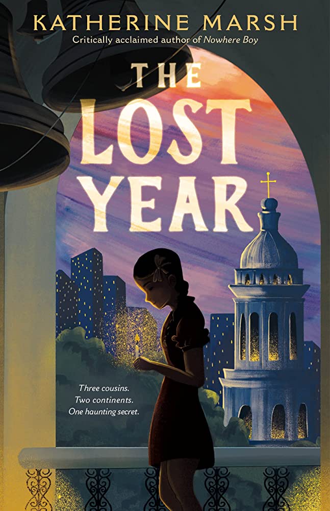 image shows a book cover featuring a girl in a bell tower lit by candlelight, with an Orthodox church and high rises behind her, and the title, "The Lost Year." Smaller, it has the tagline, "Three cousins, two continents, one haunting secret."