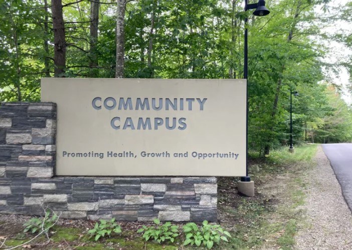 Community Campus Promoting Health Growth and Opportunity Sign on side of road
