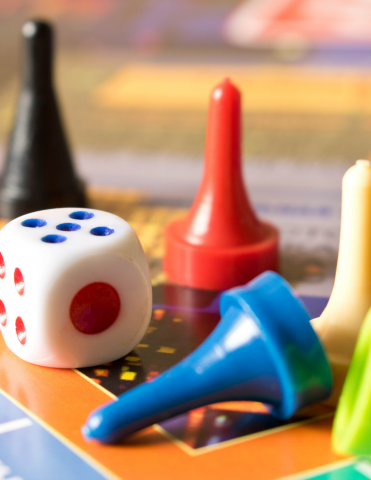 Dice and game pieces on a game board 