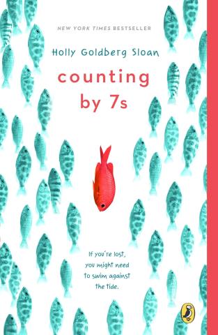 Cover of book Counting by Sevens, by Holly Goldberg Sloan, featuring a school of blue fish swimming up on a white background, while one red fish swims down in the middle