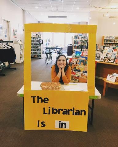 Miss Katharine sitting behind the Librarian is in sign