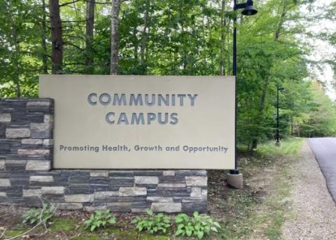 Community Campus Promoting Health Growth and Opportunity Sign on side of road