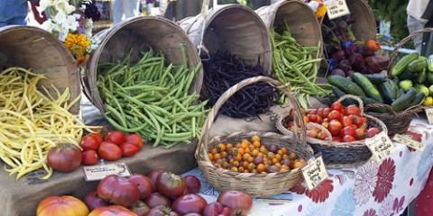 Fresh vegetables and fruit in baskets at farmers' market