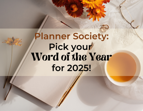 Planner Society: Pick your Word of the Year for 2025! Background is a blank journal with accents of yellow and white. A cup of tea sits near some flowers near the journal.