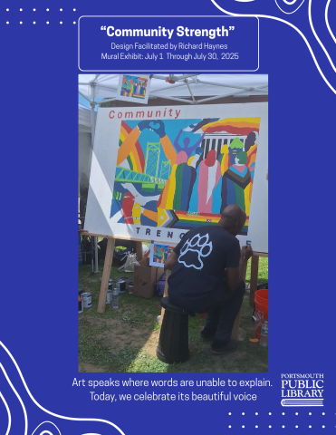 Richard Haynes sits in front of a large canvas painting a mural entitled Community Strength