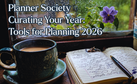 a cozy image of a cup of coffee or tea near a window, there is a journal set open with writing in it. The text says Planner Society Curating your year: Tools for Planning 2026.