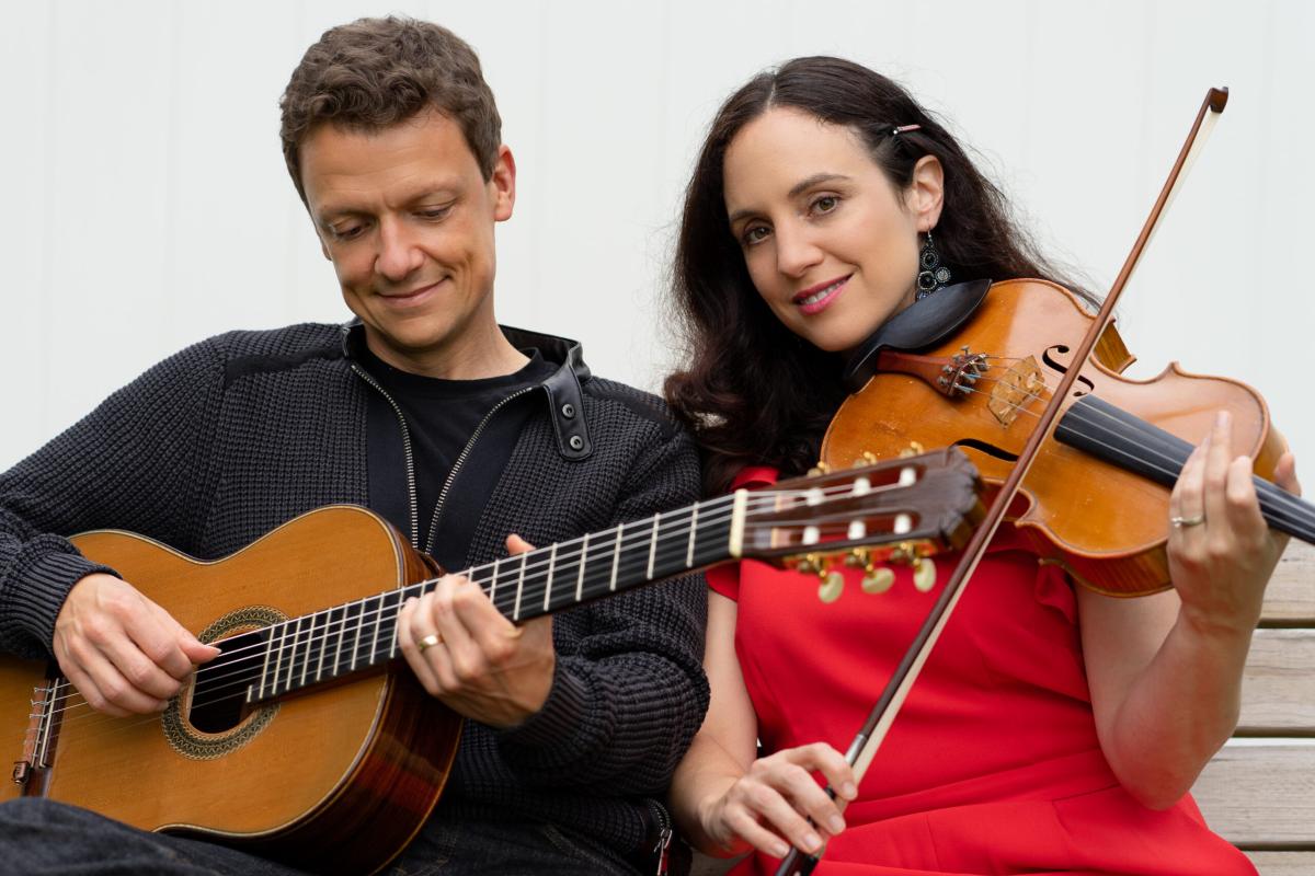 Man with Guitar and Woman with Viola seated against a white background
